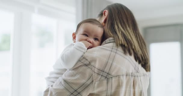 Mom, kiss or holding baby in home for love, care or quality time together to nurture child development. Mother, bond or single parent hugging infant kid for support, trust or comfort in family house. - Footage, Video
