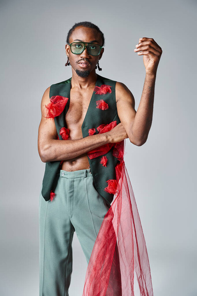 handsome african american man with sunglasses in vibrant attire looking at camera, fashion concept - Photo, Image