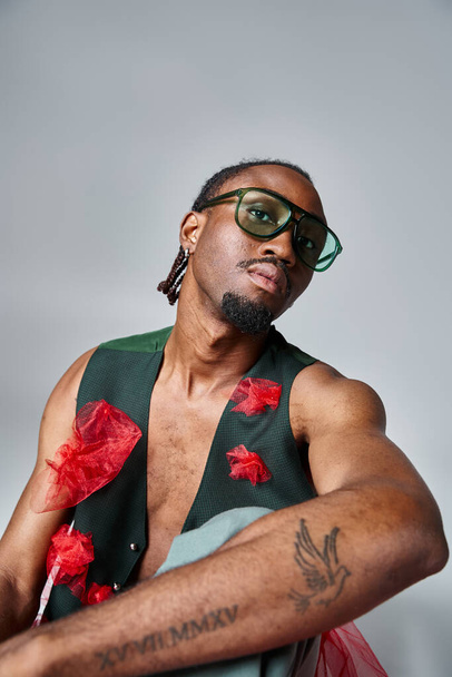 portrait of attractive african american man in vibrant clothes with sunglasses, fashion concept - Photo, Image