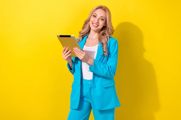 Photo of classy successful corporate lady toothy smile use tablet coworking isolated on yellow color background. - Foto, Imagen