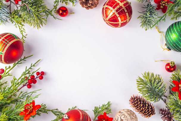 High-colored Christmas and New Year background with Christmas tree branches, fir spruce, baubles, decor and xmas flowers, top view copy space - Photo, Image