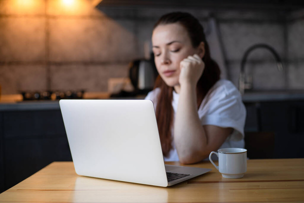 Work on the kitchen office. Remote work from home office. Young woman using laptop. Freelancer workplace at kitchen table. Distance education - Fotografie, Obrázek