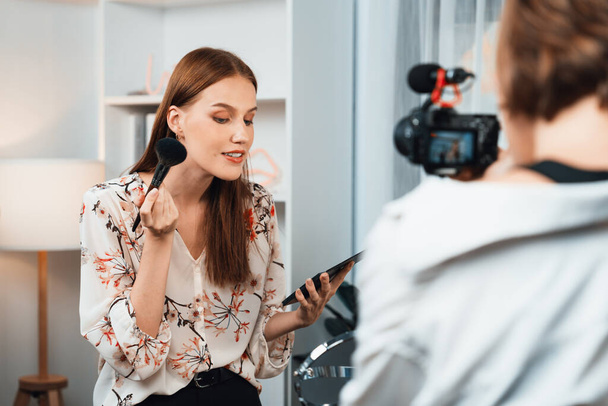 Woman influencer shoot live streaming vlog video review makeup utmost social media or blog. Happy young girl with cosmetics studio lighting for marketing recording session broadcasting online. - Photo, Image