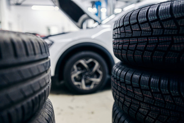 Selective focus of a new tires at mechanic's shop ready for changing. - Photo, Image