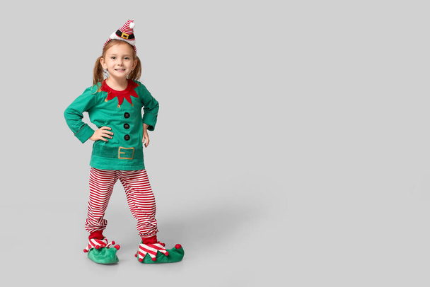 Cute little girl dressed as elf on grey background - Photo, Image