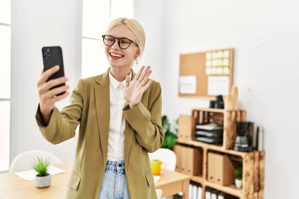 Young blonde woman business worker having video call smiling at office - Photo, Image