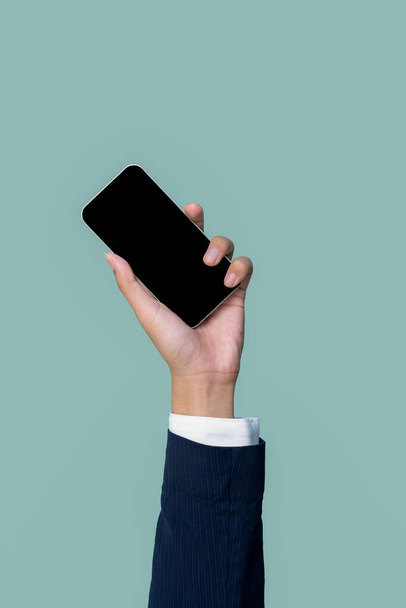 Hand holding smartphone device on isolated background for start up mobile tech company. Eco-friendly green business promoting electronic waste policy idea. Quaint - Photo, Image