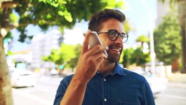 Businessman, voice and recording for message on phone, outside and city street for communication. Male person, entrepreneur and glasses with smile on face for text on mobile app, social media or web. - Footage, Video
