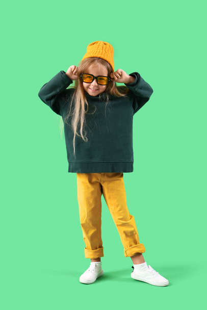 Cute little girl on green background - Photo, Image