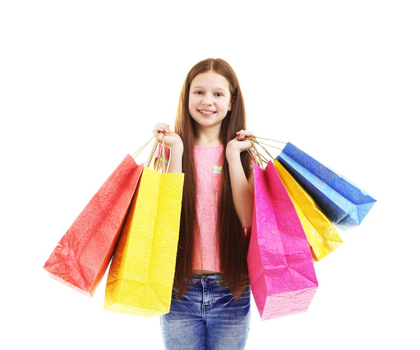 Beautiful little girl with shopping bags, isolated on white - Фото, зображення