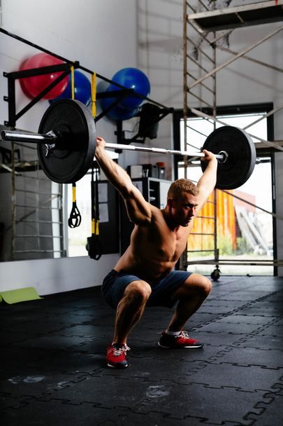 Muscular man with barbell - Фото, зображення