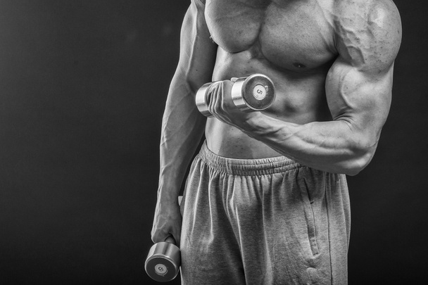 Strong man with dumbbell - Photo, Image