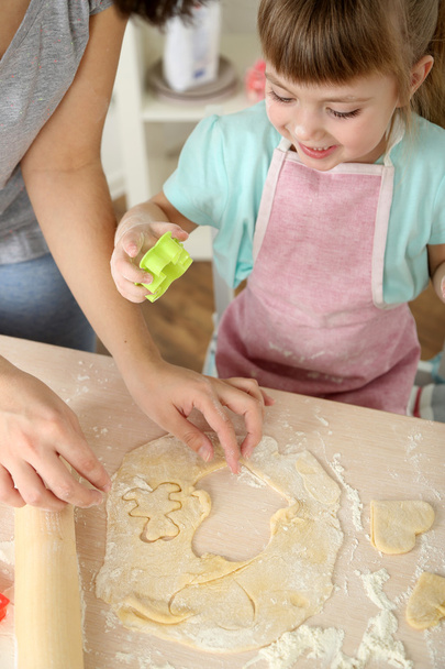 Little girl preparing cookies in kitchen at home - 写真・画像