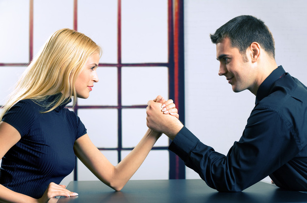 Couple or two businesspeople fighting in arm wrestling - Fotoğraf, Görsel