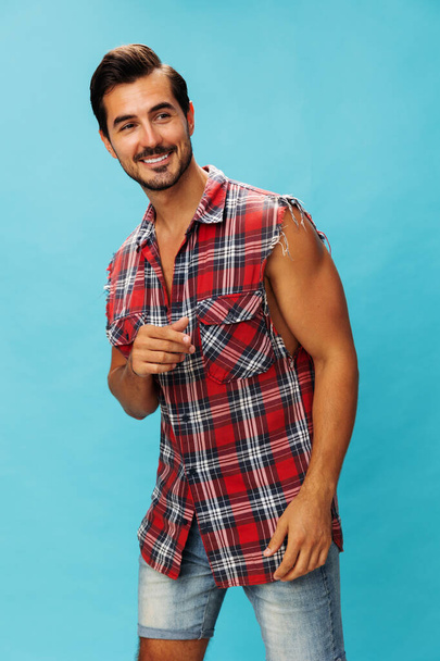 Studio man success happy standing trendy guy attractive cheerful plaid beard laughing confident looking friendly background business vacations travel crossed shirt isolated portrait arm blue smile - Photo, Image
