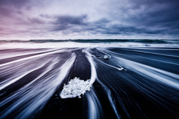 A jéghegy nagy darabjai csillognak a fekete homokon. Festői és gyönyörű jelenet. Elhelyezkedés híres hely Jokulsarlon lagúna, Vatnajokull Nemzeti Park, Sziget Izland, Európa. Szépségvilág. - Fotó, kép