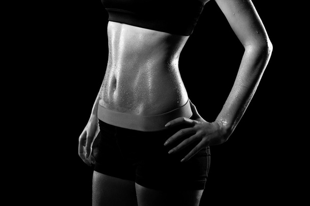 Fitness sweating woman on black background.  - Photo, Image