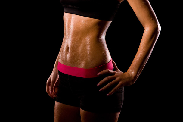 Fitness sweating woman on black background.  - Photo, image
