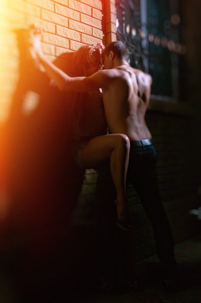 guy kissing his girlfriend against a wall at home - Photo, Image