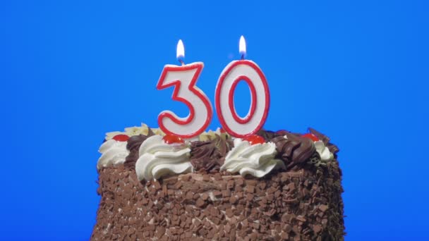 Blowing out number thirty birthday candles on a delicious chocolate cake, blue screen - Filmagem, Vídeo