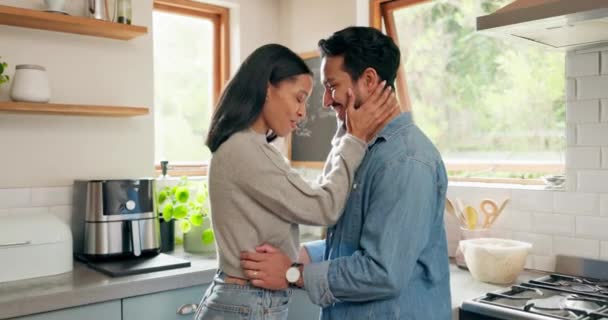 Hug, happy and couple in a kitchen bonding, intimate and talking in their home together with intimacy. Love, face and woman embrace man with smile, care and sharing romantic moment and conversation. - Footage, Video