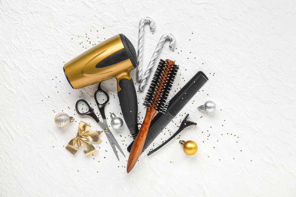 Composition with hairdresser's supplies and Christmas decorations on light background - Photo, Image