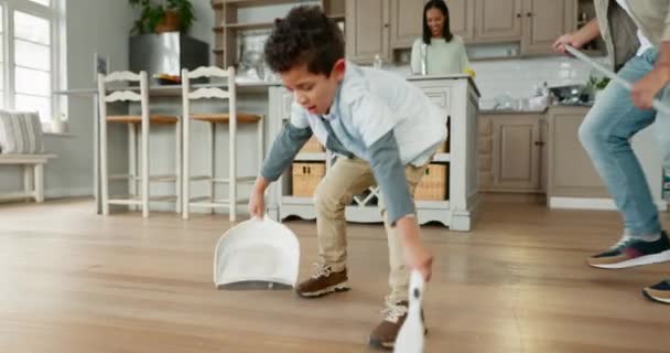 Teamwork, kid or father sweeping floor with support for housekeeping in kitchen in family home. Brush, learning or dad teaching, cleaning or helping child for healthy hygiene with broom or scoop. - Footage, Video