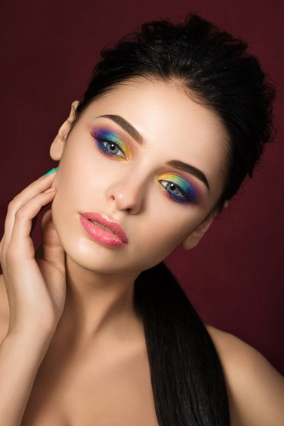 Beauty portrait of woman with colourful eye makeup - Foto, Imagen