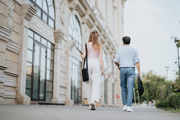 A couple explores urban city center, sharing growth strategy ideas for market expansion and profitability. Their partnership is key to successful business development. - Photo, Image