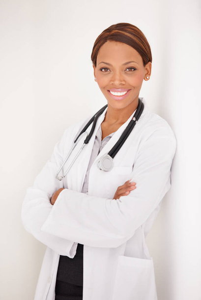 Doctor portrait, woman and arms crossed for healthcare service, clinic and hospital management on wall background. Happy face of medical worker or african person for professional health and proud job. - Photo, Image