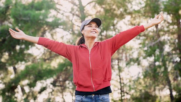 Woman arms outstretched in nature - Photo, Image