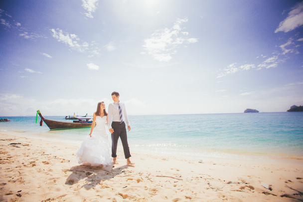 Groom and bride on sandy beach - Photo, Image