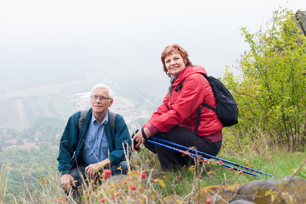 Senior couple hiking and resting in nature - Photo, Image