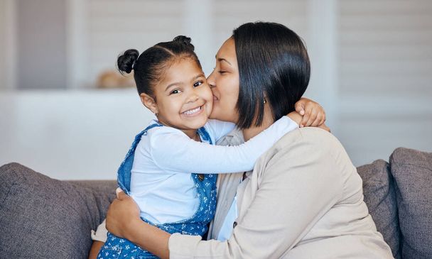Portrait, kiss and happy child hug mom, parent or mama care, support and happiness for young girl, youth or daughter. Living room couch, home affection and Mothers Day bonding, love and embrace kid. - Photo, Image