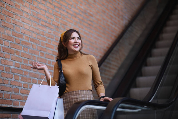 Mooie Aziatische vrouw in winkelcentrum met boodschappentassen gelukkig vrouw winkelen. - Foto, afbeelding