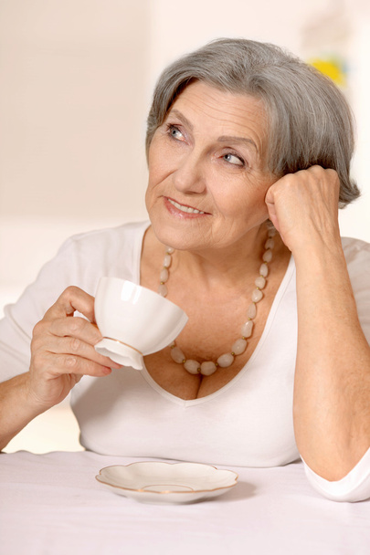 Senior woman with cup of coffee - Фото, изображение