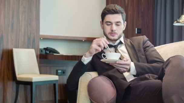 Young handsome man drinking coffee - Video, Çekim