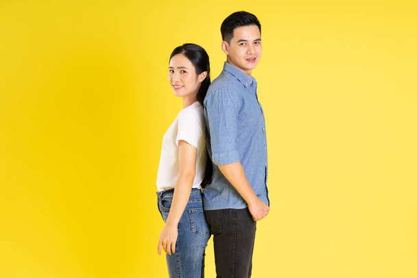 image of asian couple posing on yellow background - Photo, Image