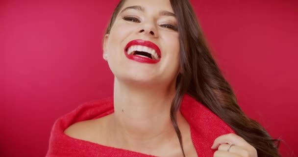 Makeup, smile and beauty with face of woman in studio for cosmetics, glamour and glow. Foundation, skincare and shine with portrait of female model on red background for lipstick, style and vanity. - Footage, Video
