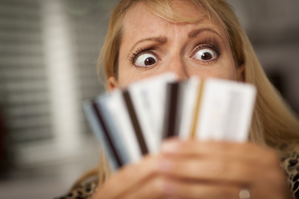 Upset Woman Glaring At Her Many Credit Cards - Photo, Image