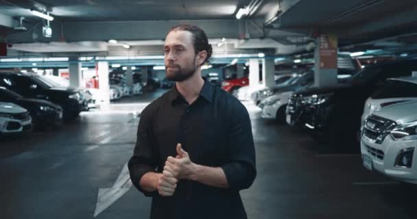 Person in underground parking lot is waiting for loved one and cannot contain his excitement. Man is very excited and worried that relative is late. Negative emotions arise from excitement of waiting - Footage, Video
