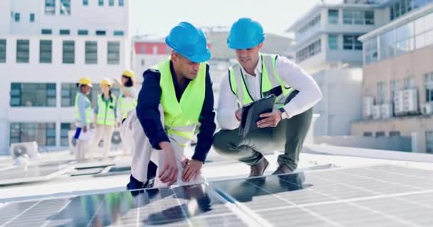 Solar panels, men and engineering discussion with tablet for planning city construction. Electrician, collaboration and team with digital technology at power grid, photovoltaic system and inspection. - Footage, Video