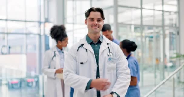 Man, doctor and arms crossed in pride for healthcare, surgery or leadership at the hospital. Portrait of happy and confident male person or medical professional in health or team management at clinic. - Footage, Video