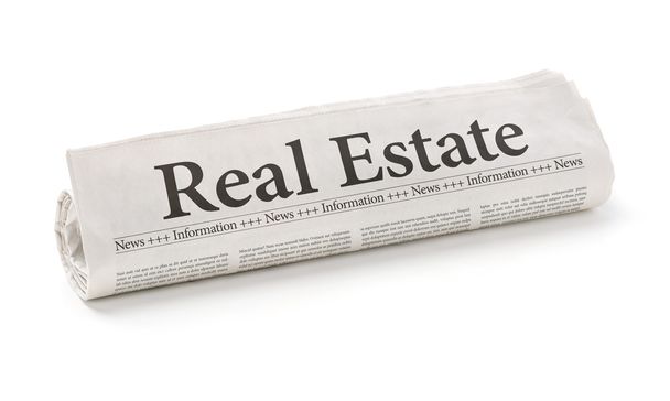 Rolled newspaper with the headline Real Estate - Photo, Image