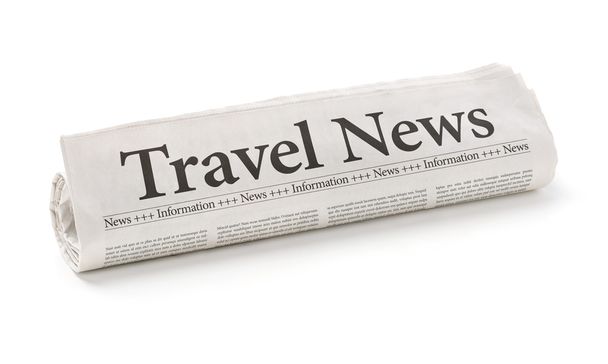 Periódico enrollado con el titular Travel News
 - Foto, Imagen