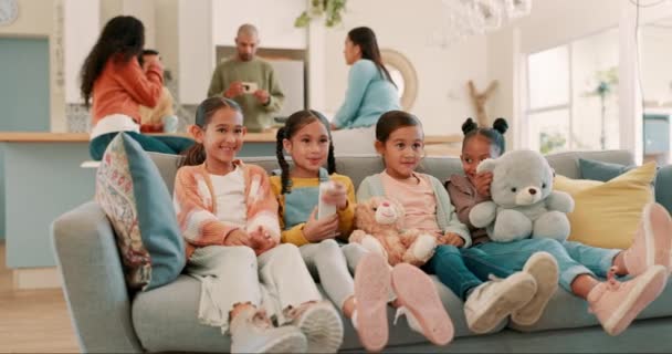 Friends, living room and children on sofa watching tv for bonding, quality time and child development. Love, friendship and kids on couch happy, relax and streaming movies, cartoon and television. - Footage, Video