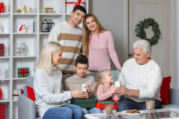 Happy family with Christmas cookies and milk at home - Photo, Image