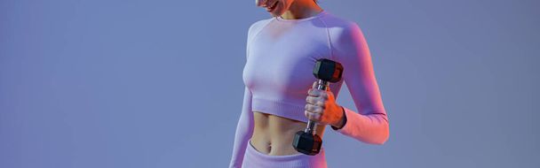 Woman doing exercises with dumbbells on studio background . Sport and healthy lifestyle - Photo, Image