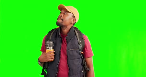Confused, lost and travel with black man on green screen for hiking, backpacking and location. Search, frustrated and direction with person on studio background for adventure, vacation and navigation. - Footage, Video