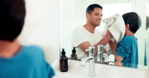Towel, washing face and father with boy in bathroom for skincare, wellness and hygiene at home together. Family, beauty and happy dad and child with for cleaning, wellbeing and health in morning. - Footage, Video